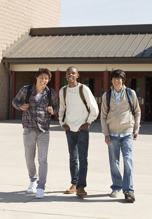 three-friends-laughing-and-walking-together-outsid-RYJSKDE.jpg